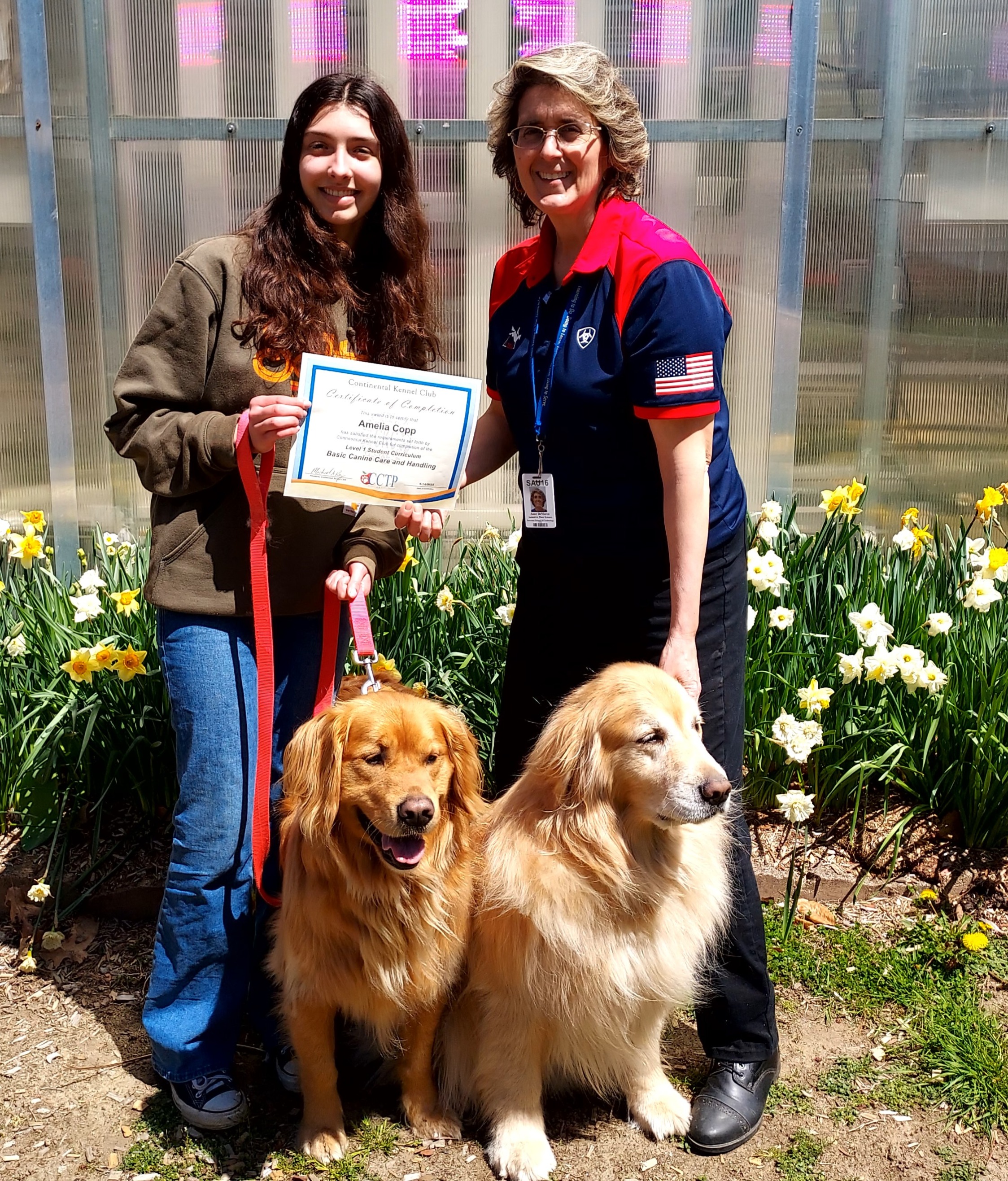 Student and teacher working with a Golden Retriever
